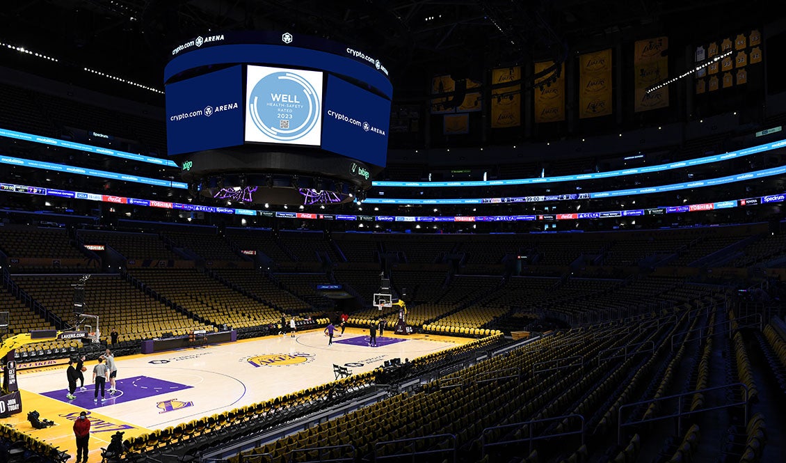 Crypto.com Arena Lakers court with the logo of the prestigious WELL Health-Safety Rating displayed on the scoreboard.